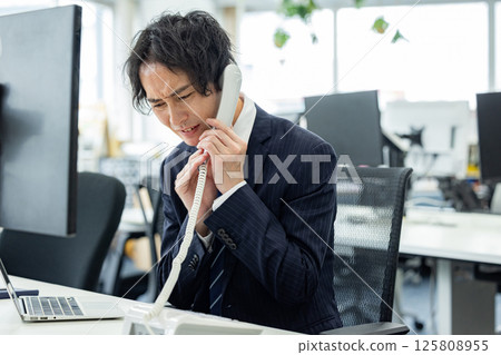 Man experiencing customer harassment 125808955