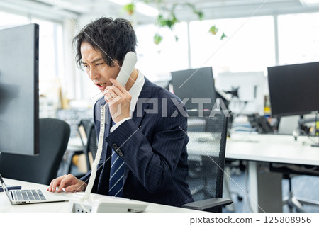 Man experiencing customer harassment 125808956