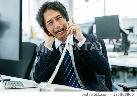 Man experiencing customer harassment 125808960