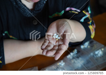 Woman taking medicine Woman taking medicine 125809785