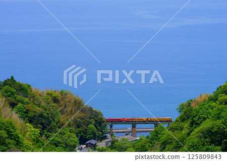 Blue sea and crimson-colored carriages: a tourist train running on the lovely Iyonada Line Blue sea and crimson-colored carriages: a tourist train running on the lovely Iyonada Line 125809843
