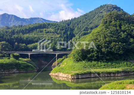 A Kitakami Line diesel train runs over Amagase Bridge on Lake Kinshu A Kitakami Line diesel train runs over Amagase Bridge on Lake Kinshu 125810134