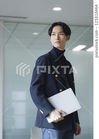 A businessman in his 30s with a laptop A businessman in his 30s with a laptop 125810464