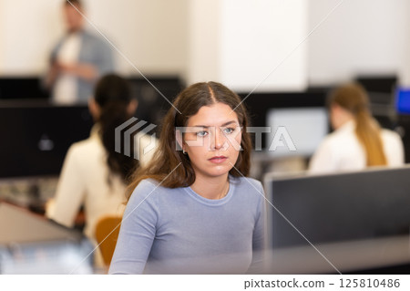 Young woman working on computer in office 125810486