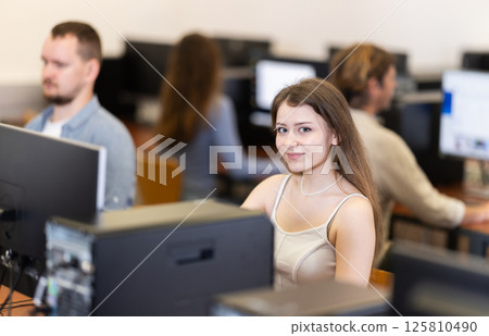 Young woman working on computer in office Young woman working on computer in office 125810490