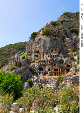 Ruins of ancient Lycian necropolis with rock-cut tombs in Demre Ruins of ancient Lycian necropolis with rock-cut tombs in Demre 125810493