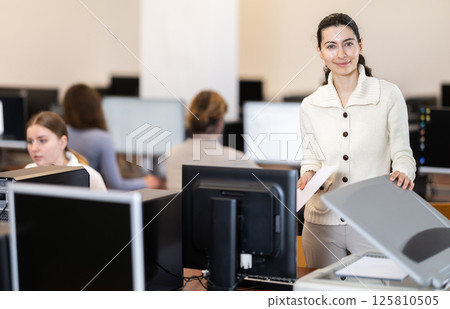 Young woman scans documents in office 125810505