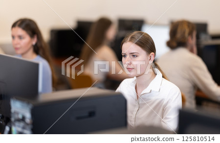 Portrait of female student studying in university computer class Portrait of female student studying in university computer class 125810514