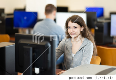 Young woman working on computer in office Young woman working on computer in office 125810518