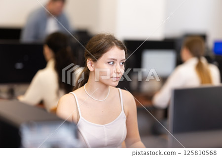 Female student at computers in university computer class Female student at computers in university computer class 125810568