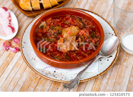 Portion of borsch served on table 125810573