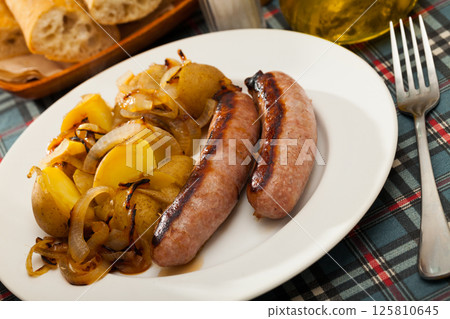 Grilled sausages with potatoes 125810645