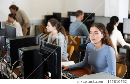 Young woman working on computer in office Young woman working on computer in office 125810762
