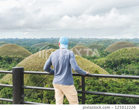 Handsome men against the backdrop of Chocolate Hills Handsome men against the backdrop of Chocolate Hills 125812226