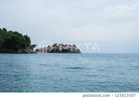 Sveti Stefan private island in Montenegro near Budva. Adriatic Sea Coast travel destination vacation holiday idea. Concept of getting away tourism experiences. Nature driven scenery 125813507