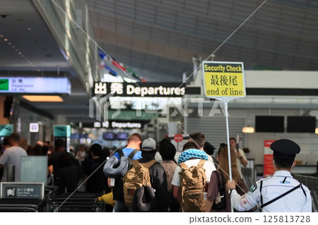 A huge queue at the security checkpoint at Haneda Airport Terminal 3. The end of the security check queue. 125813728