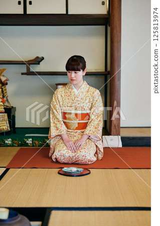 A woman in her twenties wearing a kimono experiencing a tea ceremony A woman in her twenties wearing a kimono experiencing a tea ceremony 125813974