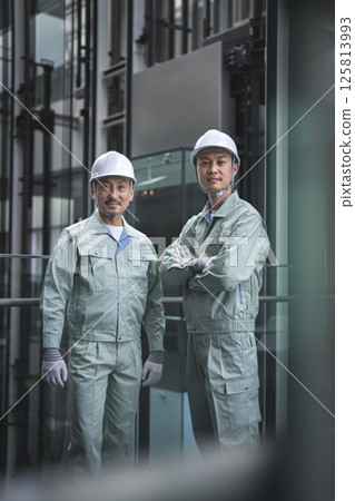 Two workers looking at the camera Two workers looking at the camera 125813993