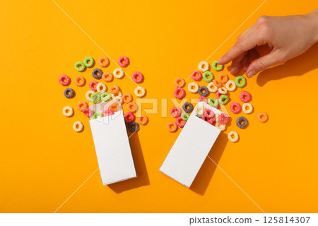 Colorful corn flakes on a yellow background 125814307