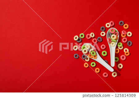 Colorful corn flakes on a red background 125814309