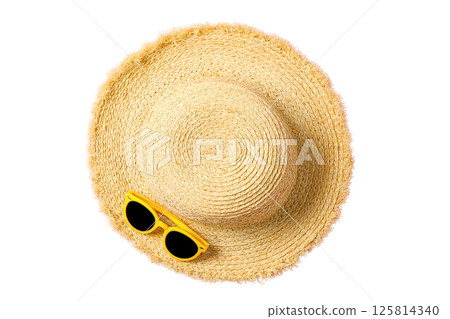 Sun hat and sunglasses ready for summer travel and adventure, isolated on white 125814340