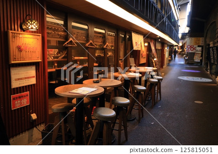 Outdoor tables at an izakaya: Bar tables lined up in a back alley Outdoor tables at an izakaya: Bar tables lined up in a back alley 125815051