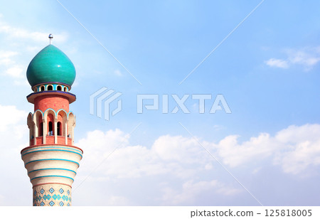 Horizontal banner with minaret of Friday Mosque against a blue sky backdrop with white clouds, Ardabil, Iran. Topic of vacation, travel, trip abroad on vacation, cruises and tours. Copy space for text Horizontal banner with minaret of Friday Mosque against a blue sky backdrop with white clouds, Ardabil, Iran. Topic of vacation, travel, trip abroad on vacation, cruises and tours. Copy space for text 125818005