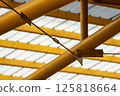 Modern Translucent Roof Structure with Yellow Steel Beams 125818664