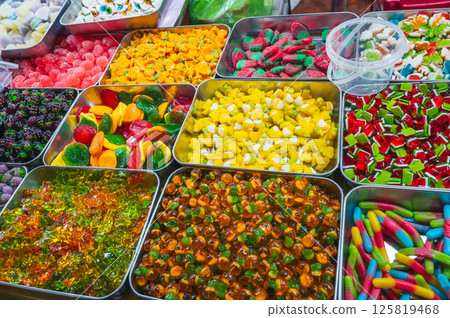 assorted colorful bright marmalade and chewable candies on the counter in store 125819468