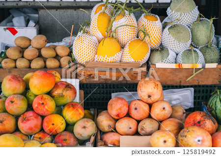 assortment of tropical fruits at Asian food market in Asia in Vietnam. Mango and Vietnamese ripe sweet fruits assortment of tropical fruits at Asian food market in Asia in Vietnam. Mango and Vietnamese ripe sweet fruits 125819492