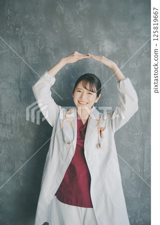 Young female doctor making a big circle with her hands Young female doctor making a big circle with her hands 125819667