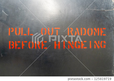 Aircraft fuselage warning message with red stencil lettering 125819719