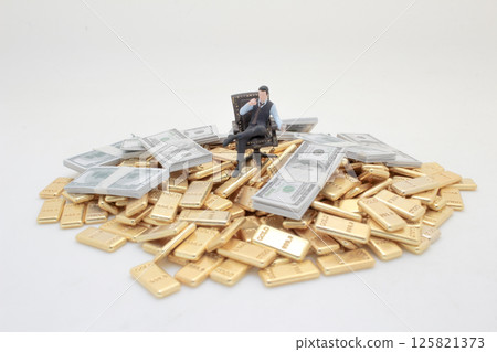 Figure Amidst Gold and Money Representing Wealth and Luxury 125821373