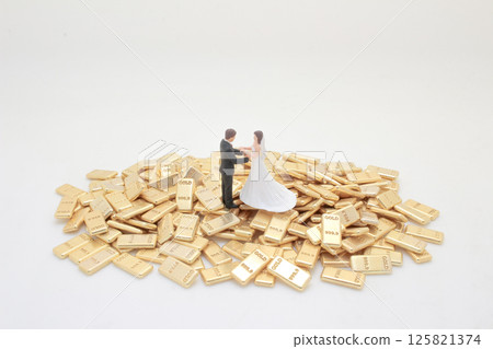 Miniature Couple Surrounded by Gold Bars and Stacks of Cash Miniature Couple Surrounded by Gold Bars and Stacks of Cash 125821374