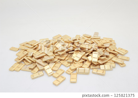 Pile of Shiny Gold Bullion Bars with High Purity Numbers Visible 125821375