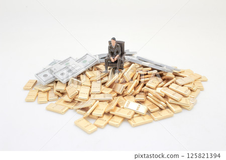 Figure Amidst Gold and Money Representing Wealth and Luxury 125821394