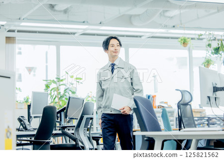 A young man wearing work clothes A young man wearing work clothes 125821562