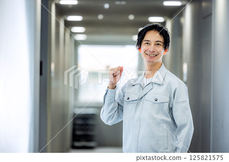 Young engineer standing in the office corridor Young engineer standing in the office corridor 125821575