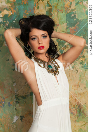 Gorgeous fashion woman in white silk dress posing in perfect interior Gorgeous fashion woman in white silk dress posing in perfect interior 125821592