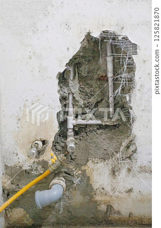 Hole in old building, drain pipes, renovating plumbing 125821870