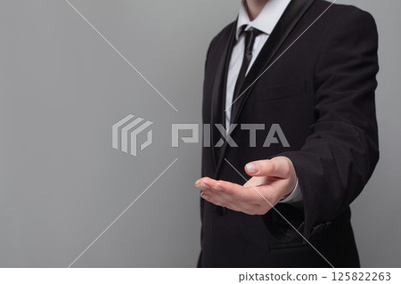A young businessman extends his hand 125822263