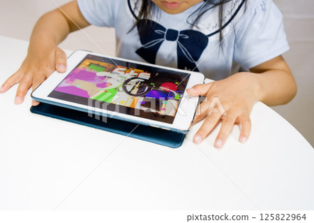 Girl playing with tablet-4 Girl playing with tablet-4 125822964