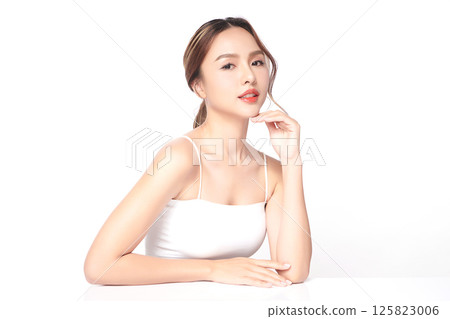A beautiful young Asian woman with clean, fresh skin against a white background. Skincare, facial treatment, cosmetology, beauty, and spa. An elegant portrait of an Asian woman. A beautiful young Asian woman with clean, fresh skin against a white background. Skincare, facial treatment, cosmetology, beauty, and spa. An elegant portrait of an Asian woman. 125823006