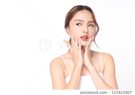 A beautiful young Asian woman with clean, fresh skin against a white background. Skincare, facial treatment, cosmetology, beauty, and spa. An elegant portrait of an Asian woman. 125823007