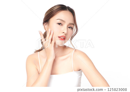 A beautiful young Asian woman with clean, fresh skin against a white background. Skincare, facial treatment, cosmetology, beauty, and spa. An elegant portrait of an Asian woman. A beautiful young Asian woman with clean, fresh skin against a white background. Skincare, facial treatment, cosmetology, beauty, and spa. An elegant portrait of an Asian woman. 125823008