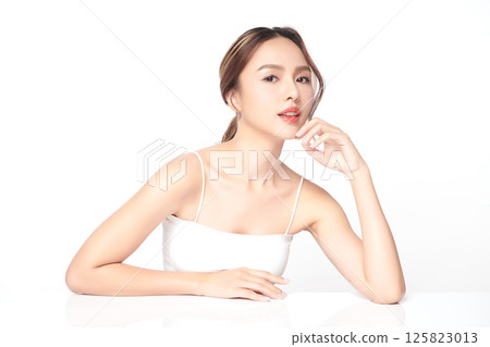 A beautiful young Asian woman with clean, fresh skin against a white background. Skincare, facial treatment, cosmetology, beauty, and spa. An elegant portrait of an Asian woman. A beautiful young Asian woman with clean, fresh skin against a white background. Skincare, facial treatment, cosmetology, beauty, and spa. An elegant portrait of an Asian woman. 125823013