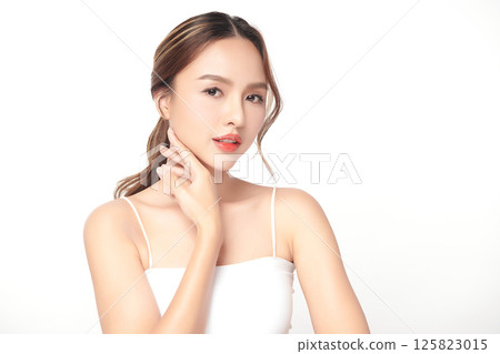 A beautiful young Asian woman with clean, fresh skin against a white background. Skincare, facial treatment, cosmetology, beauty, and spa. An elegant portrait of an Asian woman. A beautiful young Asian woman with clean, fresh skin against a white background. Skincare, facial treatment, cosmetology, beauty, and spa. An elegant portrait of an Asian woman. 125823015