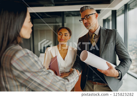 A crucial Business Team Meeting is taking place in a cuttingedge Modern Office setting 125823282