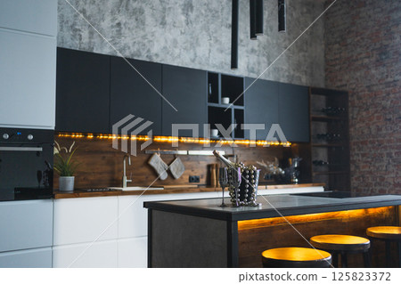 Empty Scandinavian classic minimalistic dark gray kitchen with wooden details. Stylish loft modern black gray white kitchen decoration with clean contemporary style interior design 125823372