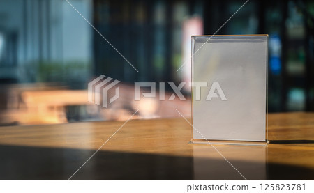 Stand Mock up Menu frame tent card blurred background design key visual layout A modern acrylic stand on the counter displays 125823781